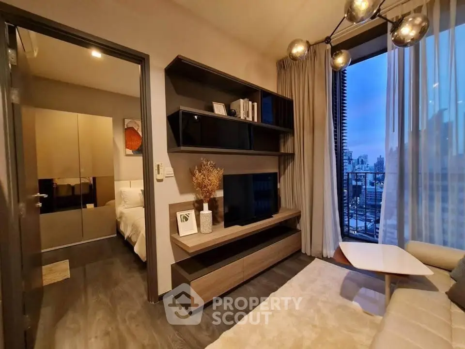 Modern living room with elegant shelving and city view from balcony, featuring stylish lighting and cozy decor.