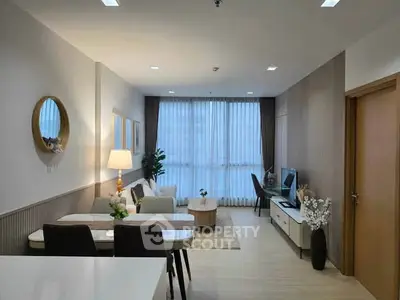 Modern living room with elegant dining area and natural light