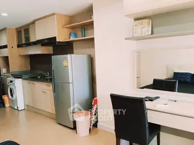 Modern apartment kitchen with sleek appliances and cozy workspace