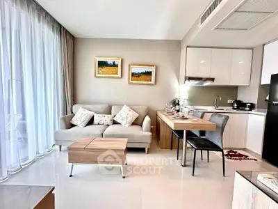 Modern living room with open kitchen, cozy sofa, and elegant decor