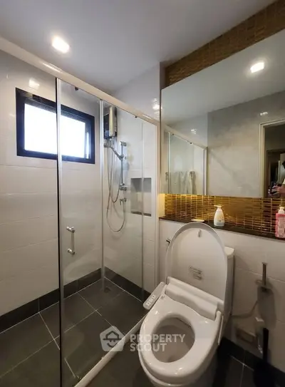 Modern bathroom with glass shower and sleek toilet design