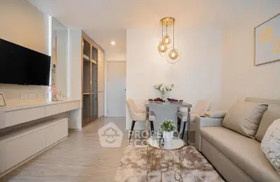 Modern living room with elegant decor and cozy dining area, featuring stylish lighting and neutral tones.