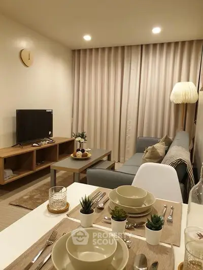 Cozy living room with modern decor and dining area in open layout apartment.