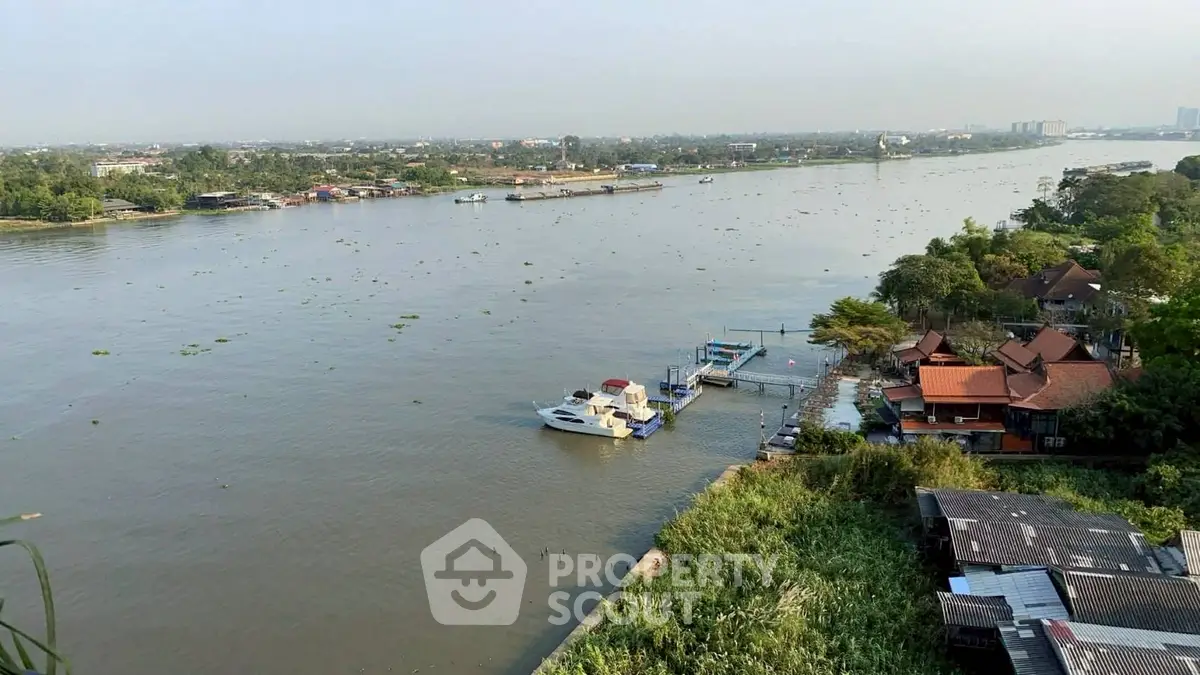 Stunning river view from a high vantage point, showcasing serene waters and lush greenery, perfect for tranquil living.