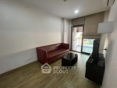 Modern living room with red sofa and balcony access in urban apartment
