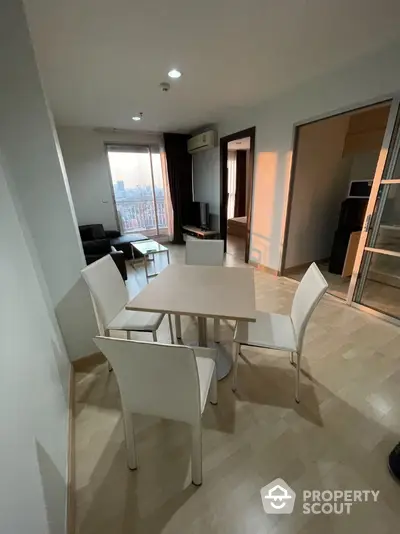 Modern apartment dining area with natural light and city view