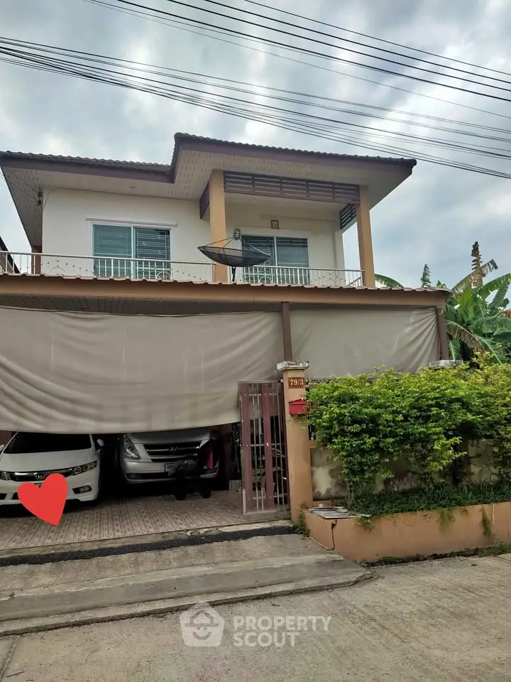 Charming two-story house with spacious garage and lush greenery in a serene neighborhood.