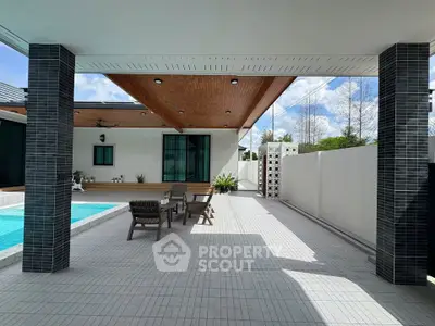 Modern outdoor patio with pool and stylish seating area in contemporary home.