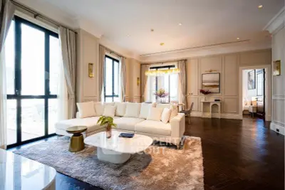 Luxurious living room with elegant decor and large windows in a modern apartment.