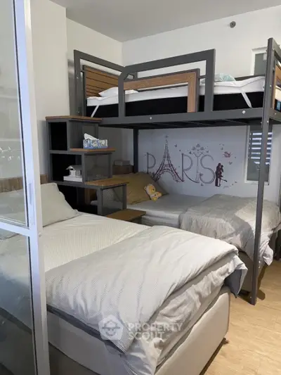 Cozy bedroom with modern bunk beds, stylish Paris-themed wall art, and ample storage, perfect for a small family or roommates.