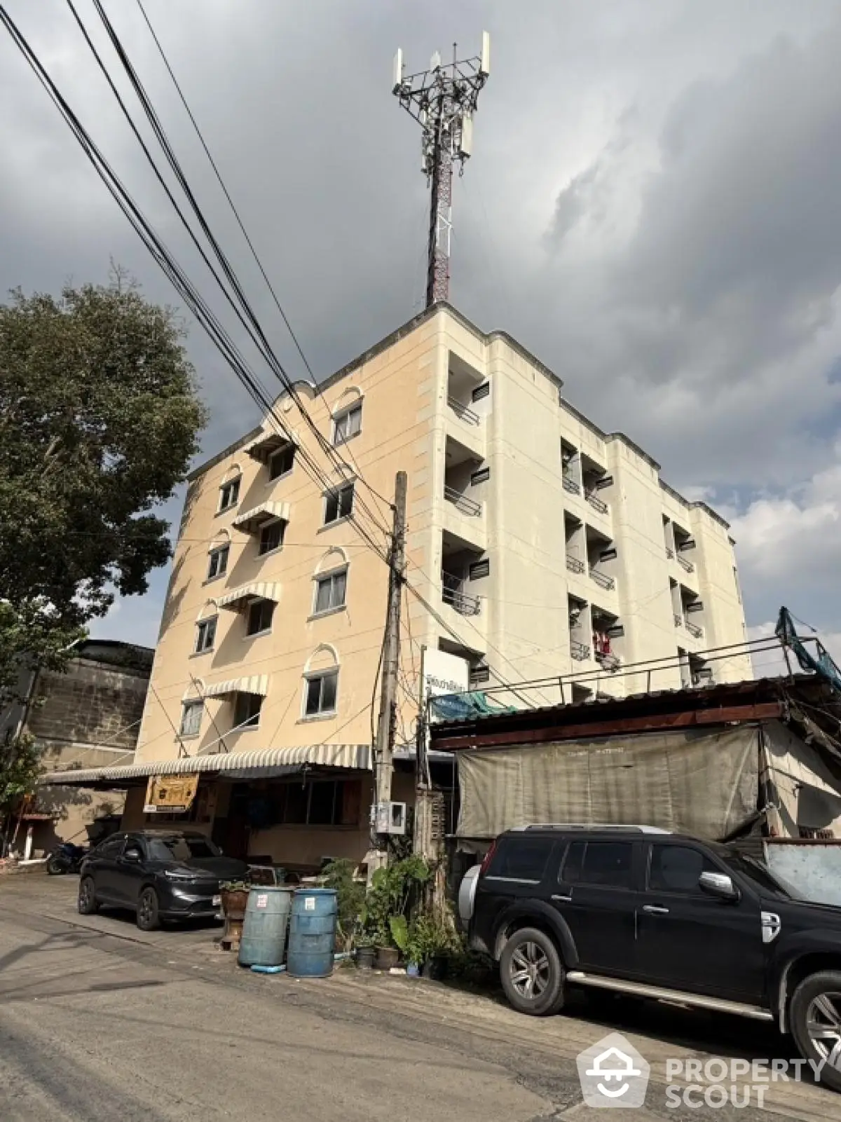 Urban apartment building with parking and street view