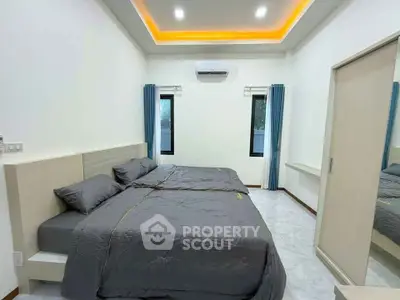 Spacious modern bedroom with twin beds and sleek design