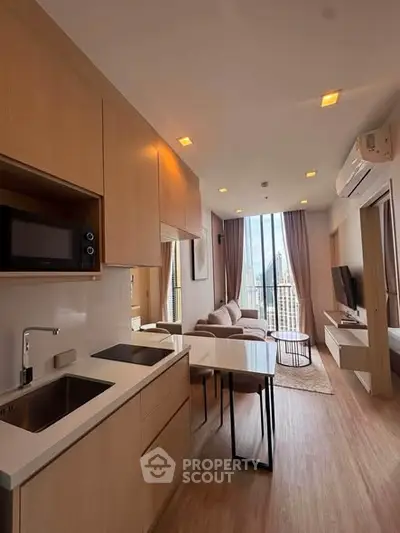 Modern open-layout kitchen and living room with city view in high-rise apartment
