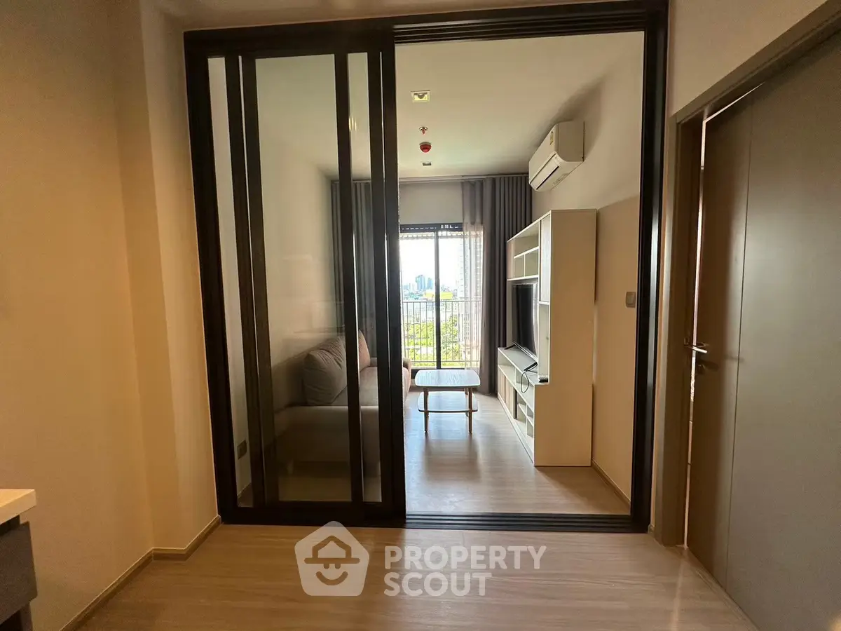 Modern living room with sliding glass doors and city view