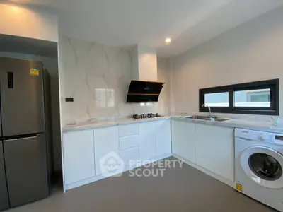 Modern kitchen with sleek appliances and marble backsplash
