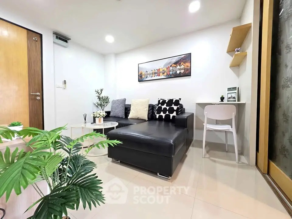 Modern living room with stylish black sofa and chic decor
