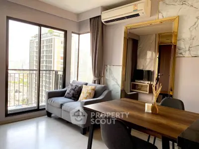 Modern living room with city view, featuring a cozy sofa and dining area.