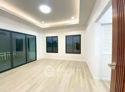 Spacious modern living room with large windows and elegant lighting