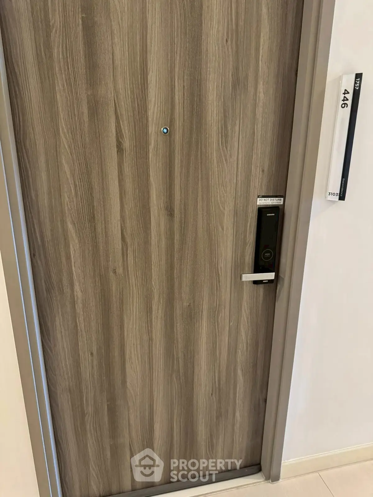 Modern apartment entrance with sleek wooden door and digital lock