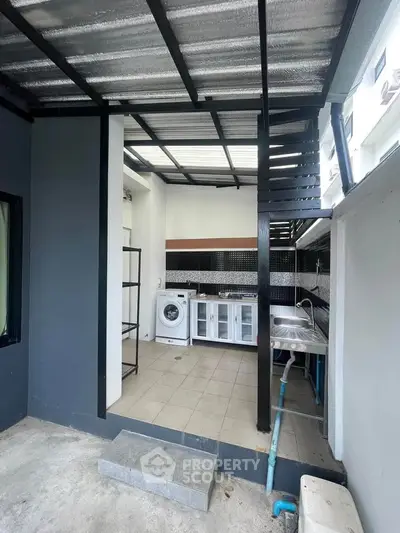 Modern outdoor kitchen with washing machine and sleek design