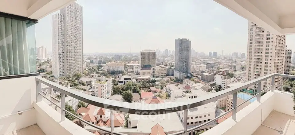 Stunning panoramic city view from a high-rise balcony, showcasing urban skyline and modern architecture.