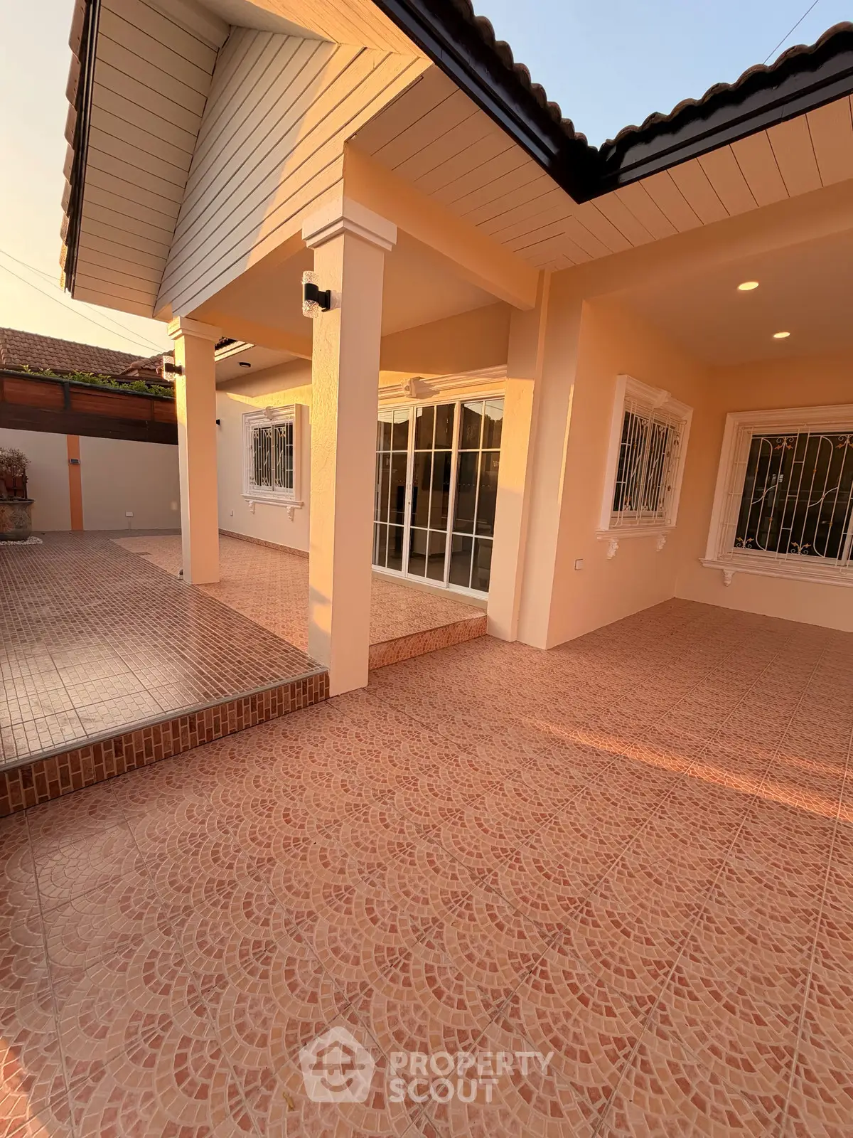 Charming single-story home with spacious tiled patio and elegant exterior design.