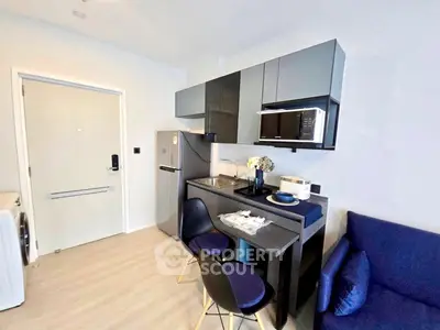 Modern compact kitchen with sleek cabinets and dining area in stylish apartment