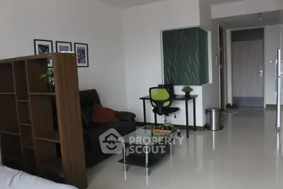 Spacious and modern living room with sleek furniture, glossy tiled flooring, and a cozy study corner featuring a blackboard, ideal for relaxation or work from home setup.