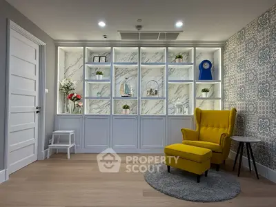 Stylish living room with elegant shelving and vibrant yellow armchair