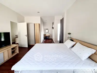 Spacious modern bedroom with sleek furniture and ample natural light