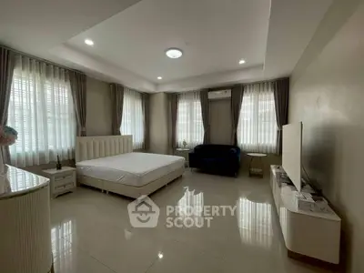 Spacious bedroom with modern decor and ample natural light