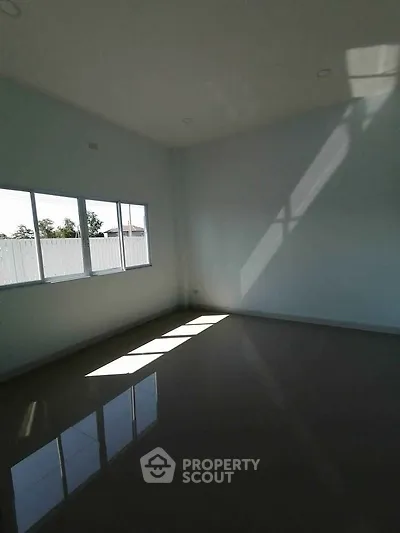 Spacious empty room with large windows and glossy tiled floor, perfect for customization.