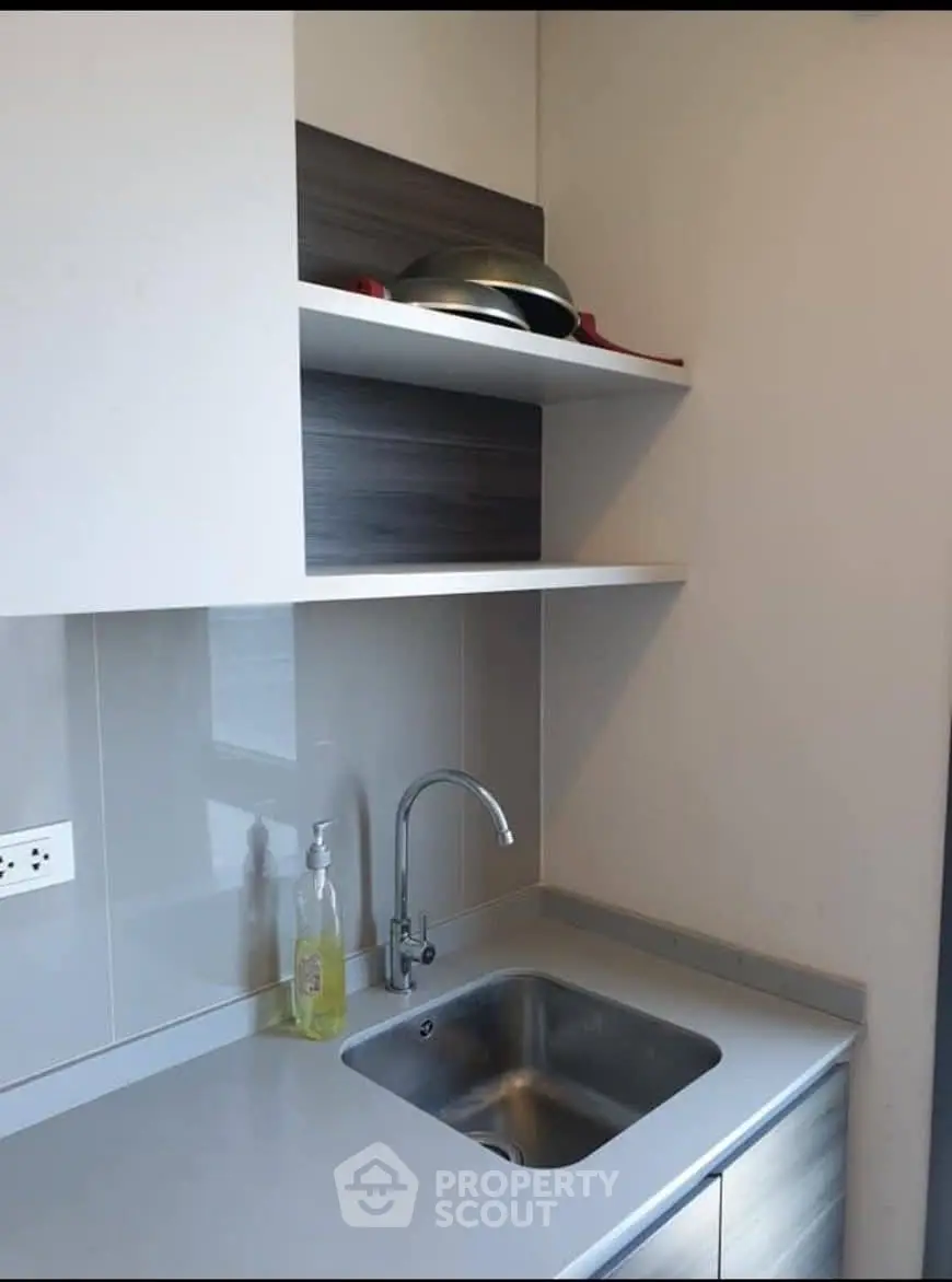 Modern kitchen with sleek countertop and stainless steel sink