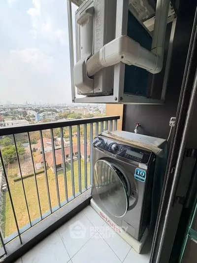 High-rise balcony with washing machine and city view, perfect for urban living convenience.