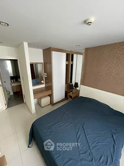Modern bedroom with stylish wardrobe and cozy bed in a contemporary apartment.