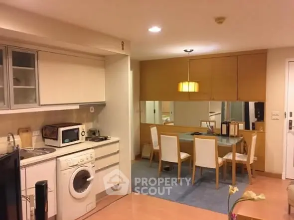 Charming open-layout kitchen and dining area with modern appliances and cozy ambiance.