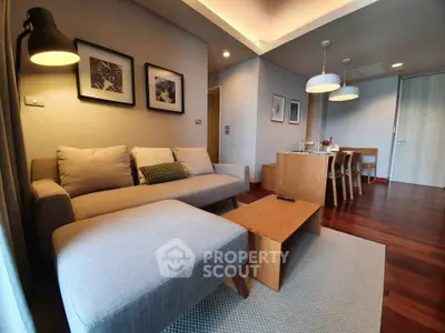 Modern living room with cozy sofa and dining area, perfect for relaxation and entertaining.