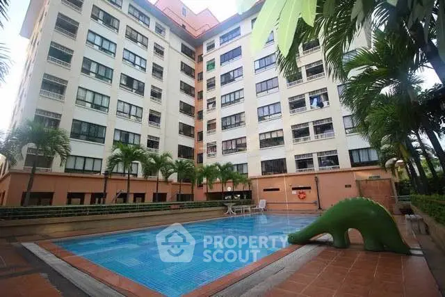 Spacious condominium with inviting pool and lush greenery, perfect for relaxation and leisure.