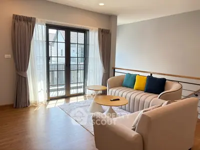 Bright and airy living room with modern furniture and large windows opening to a balcony.