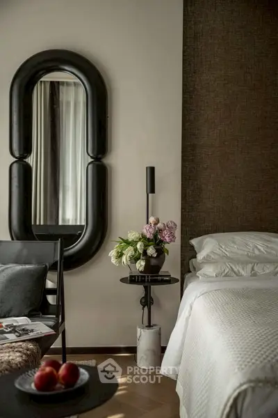 Luxurious bedroom with elegant decor and stylish mirror, perfect for modern living.