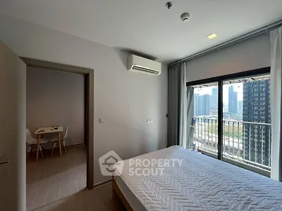 Modern bedroom with balcony view in high-rise apartment