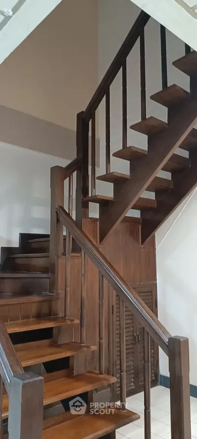 Elegant wooden staircase with modern design in a stylish home interior.