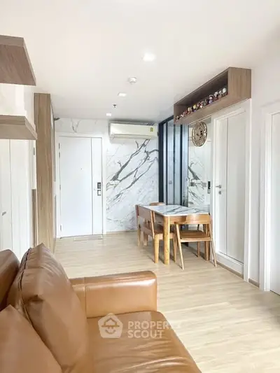 Modern living room with marble accents and cozy leather sofa