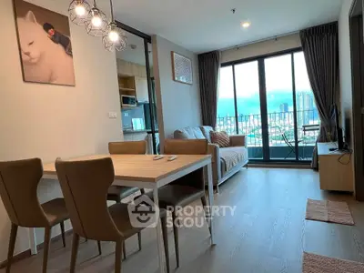 Modern living room with dining area and balcony view in a stylish apartment.