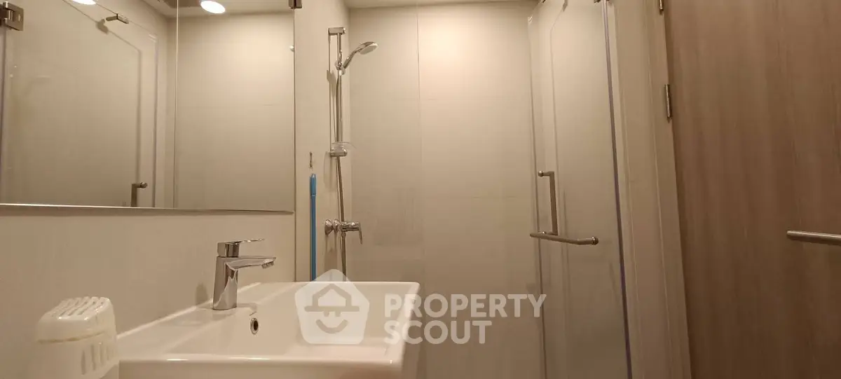 Modern bathroom with sleek fixtures and glass shower enclosure