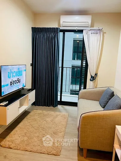 Cozy living room with modern decor and balcony access in a stylish apartment.