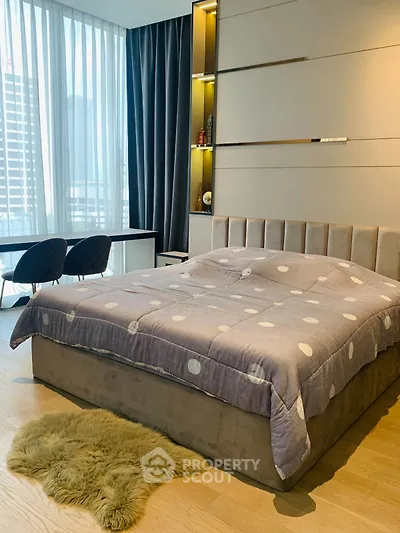 Luxurious bedroom with modern decor and city view, featuring a plush bed and elegant furnishings.