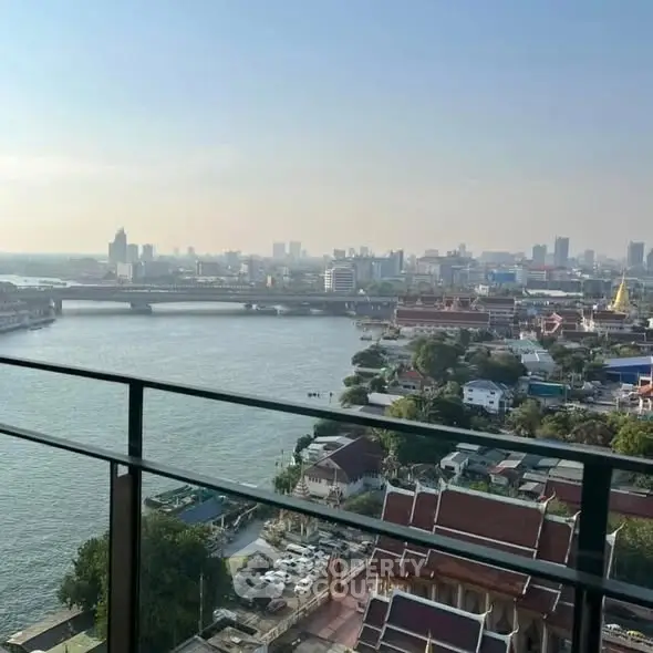 Stunning river view from high-rise balcony overlooking cityscape and skyline.