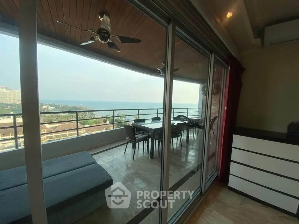 Spacious balcony with stunning ocean view, perfect for relaxation and entertainment.