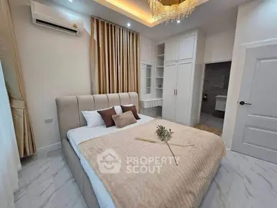 Luxurious bedroom with elegant decor and ensuite bathroom, featuring plush bedding and ambient lighting.
